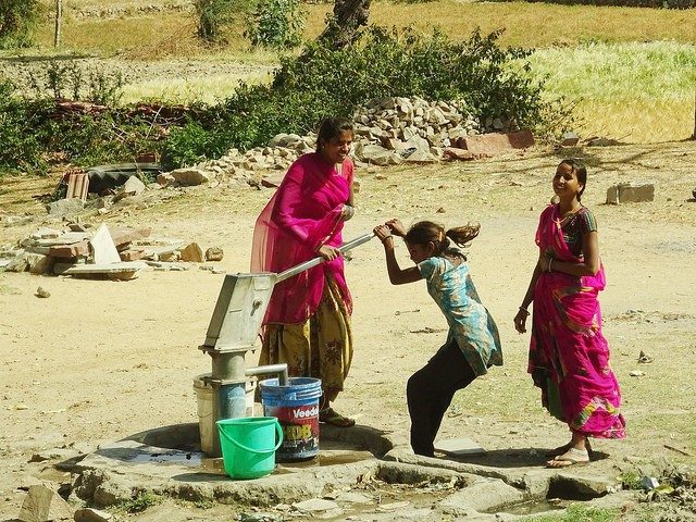 people at a water pump