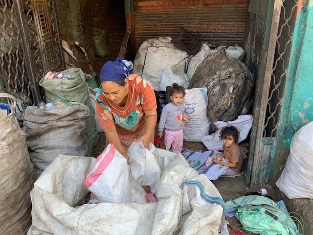 A Zabaleen woman sorting through garbage to salvage recyclables.