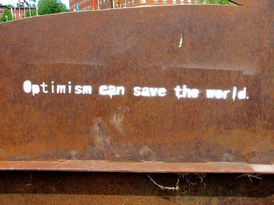 Image says "Optimism can save the world"