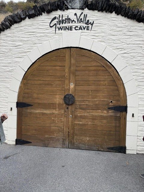 wooden door entrance to gibbston valley wine cave