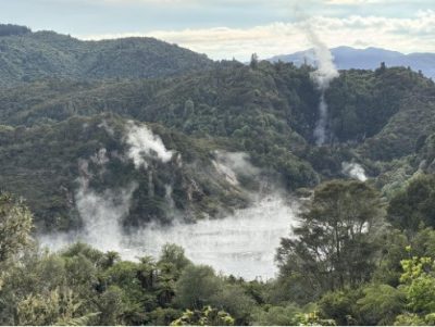 steam rising from lake with trees in background