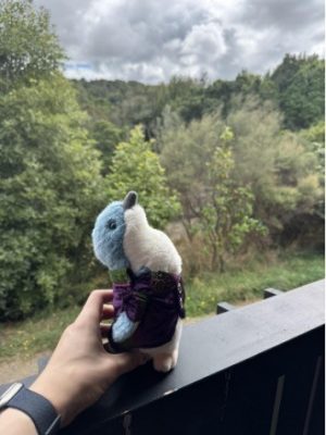 stuffed toy bird in front of trees