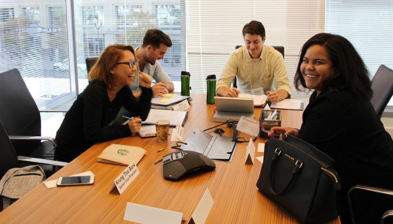 students at a conference table