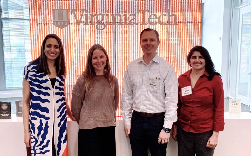 Photo of four XMNR alumni Meenu Hochwalt, Beth DeNoia-Feliciano, Joe Tannery, and Nikki Mehta at the XMNR classroom in Arlington, VA
