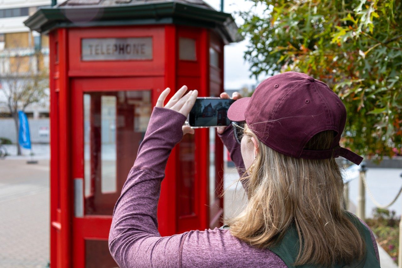 online master of natural resources olivia powell taking a picture with phone.
