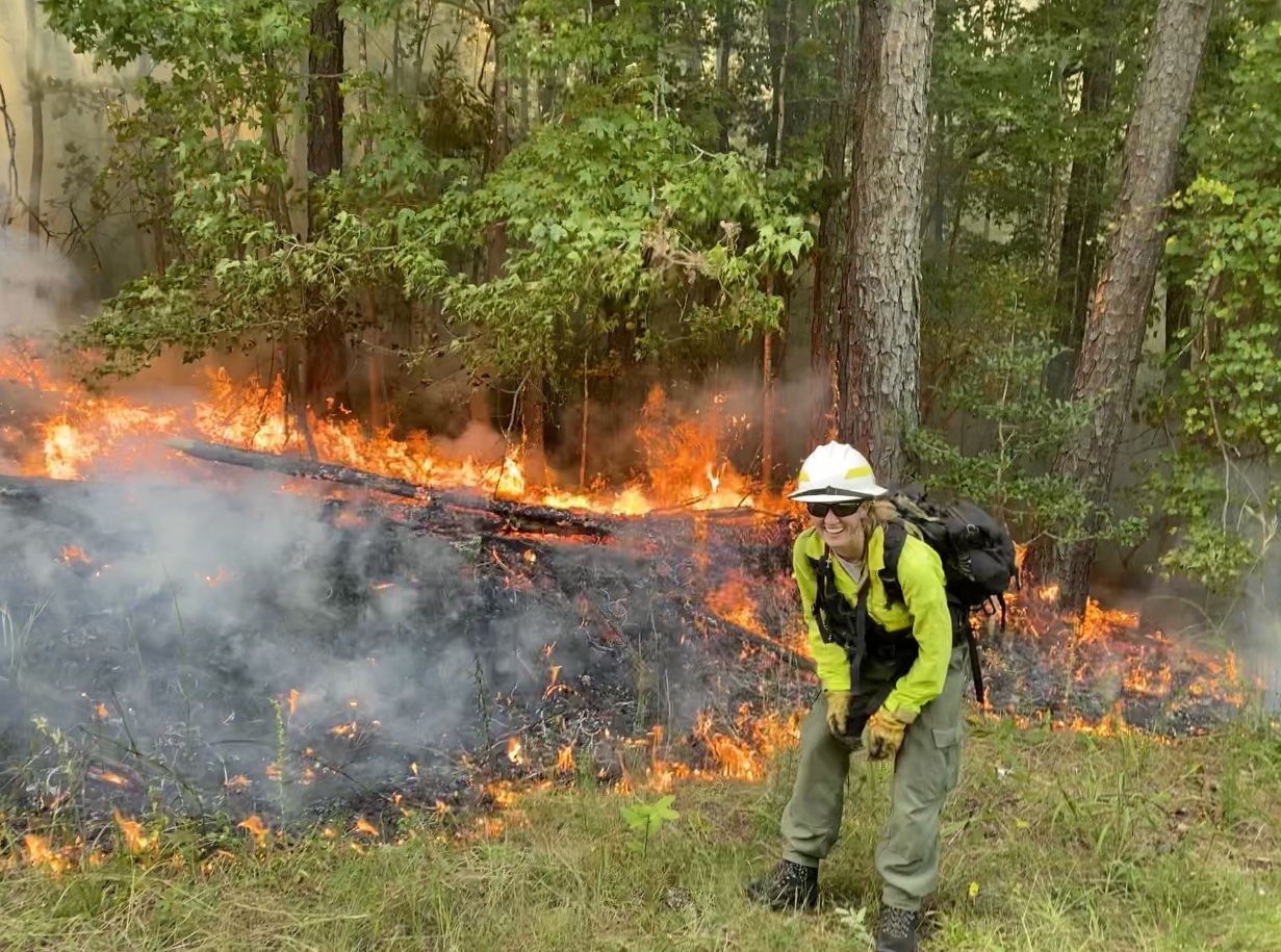 Kayci Willis in front of one of her first prescribed burns; Photo: Kayci Willis