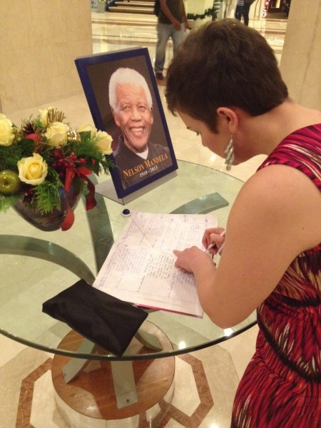 signing a condolence when Mandela passed