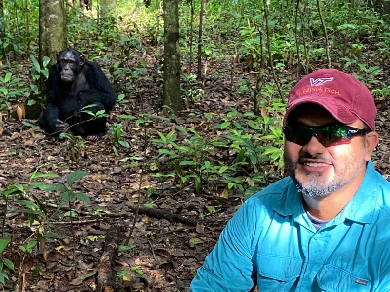 Dr. Omchand Mahdu on a chimp tracking trip in Uganda.