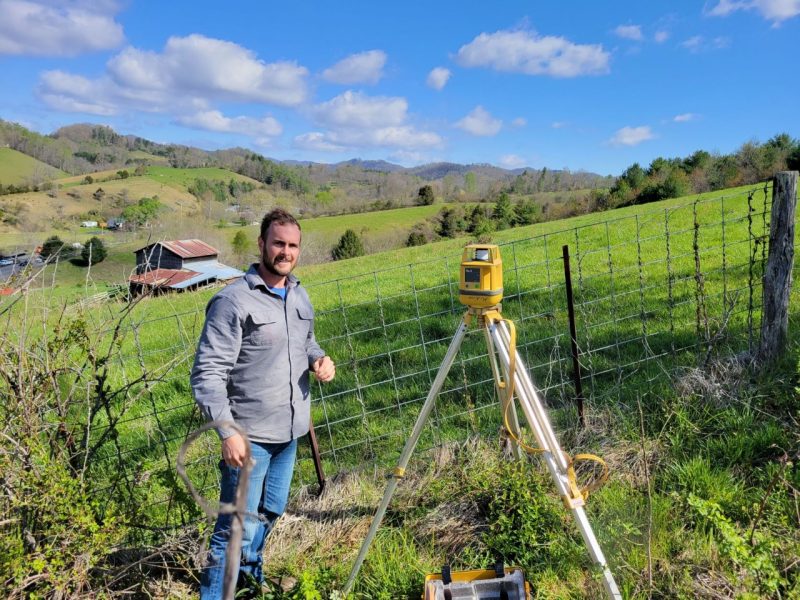 Richard is surveying at a local farm to design a cattle watering system. In fencing out waterways, the practice decreases non-point source pollution, mitigates erosion, and preserves bank vegetation.
