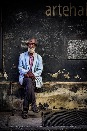 Man sitting on the street in Cuba