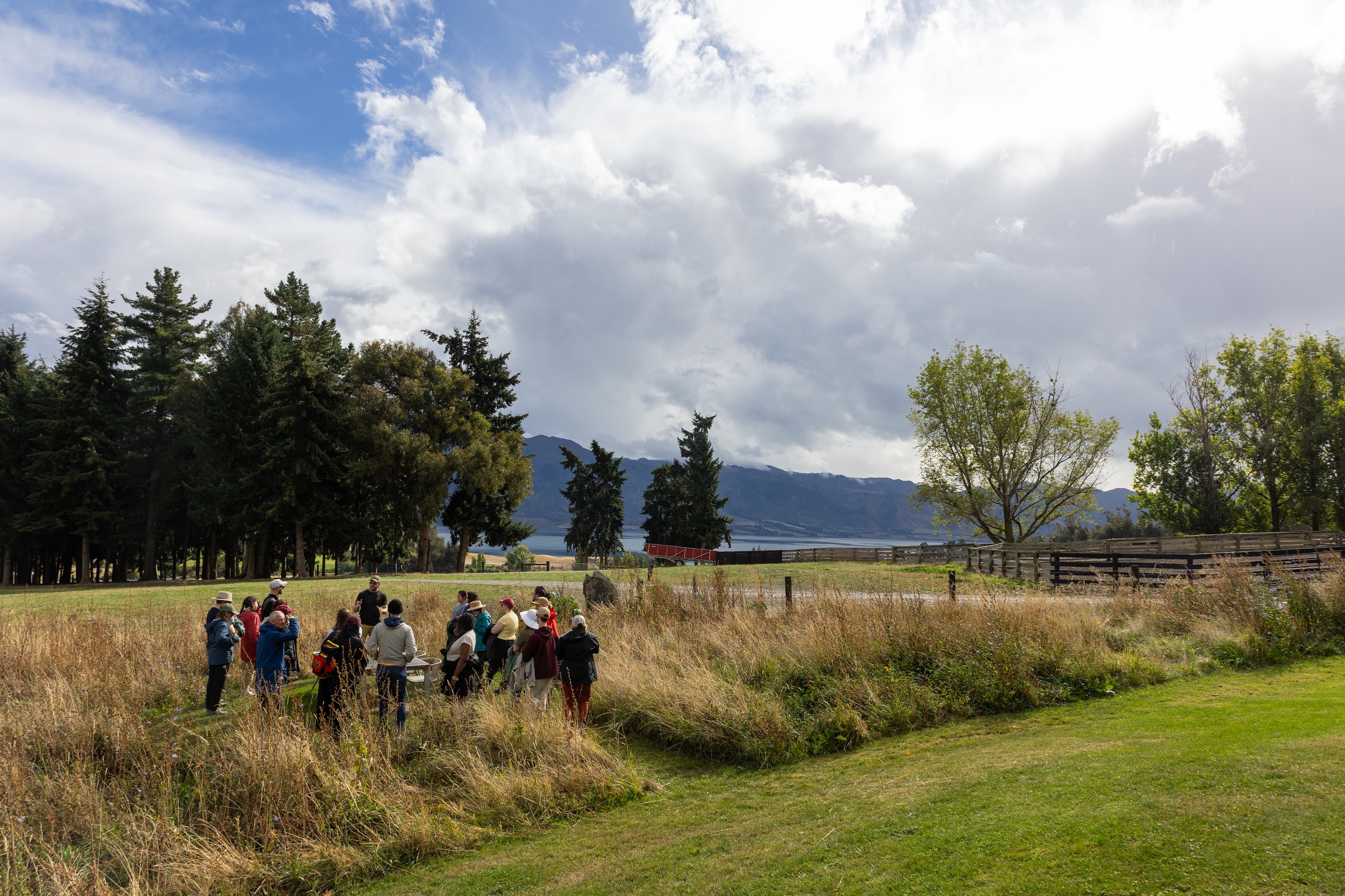 a group stands in a field on a farm